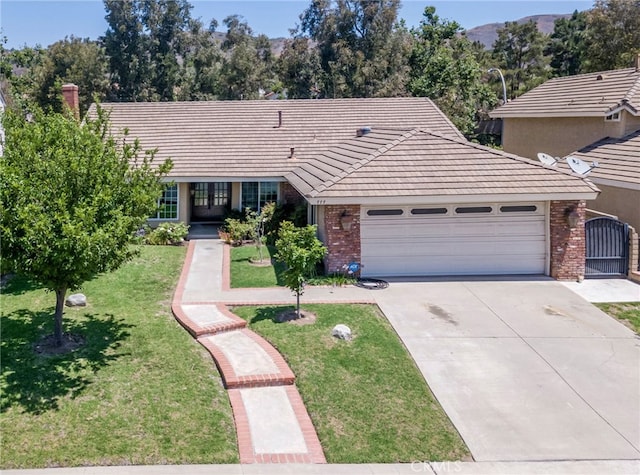 777 Oak Knoll St, Brea, CA 92821 - single story home featuring brick siding, an attached garage, driveway, and a front yard