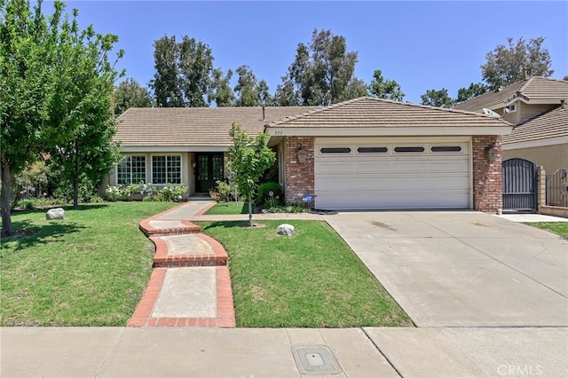 777 Oak Knoll St, Brea, CA 92821 - ranch-style home featuring an attached garage, driveway, a front lawn, and a tiled roof