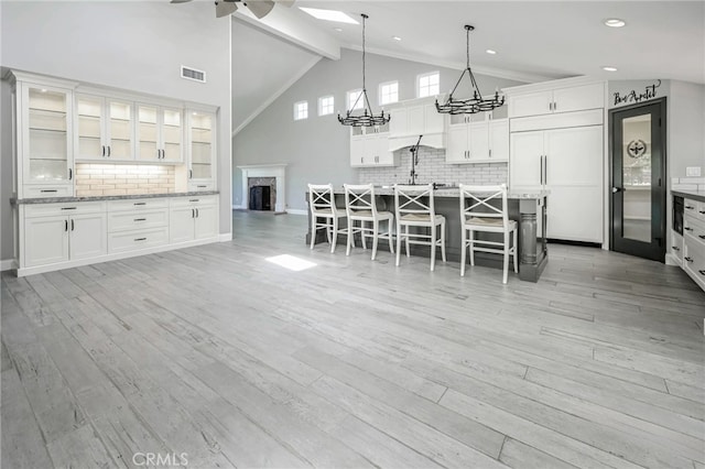 777 Oak Knoll St, Brea, CA 92821 - kitchen featuring a chandelier, tasteful backsplash, a kitchen breakfast bar, a ceiling fan, and high vaulted ceiling