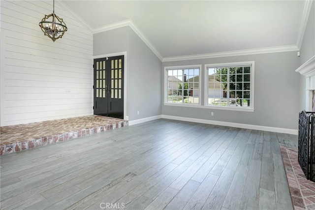 777 Oak Knoll St, Brea, CA 92821 - unfurnished living room with a chandelier, dark wood-style flooring, ornamental molding, lofted ceiling, and a fireplace