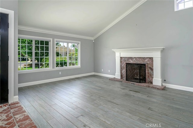 777 Oak Knoll St, Brea, CA 92821 - unfurnished living room featuring vaulted ceiling, a fireplace with raised hearth, crown molding, and wood finished floors