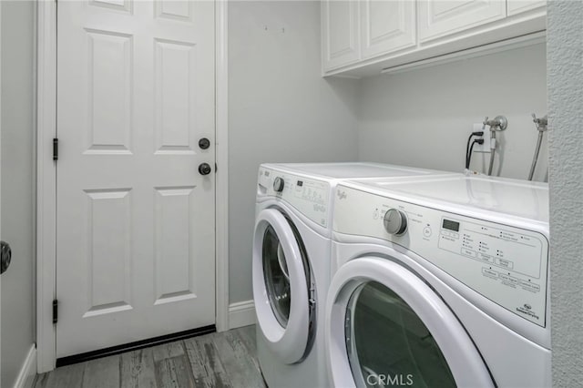 777 Oak Knoll St, Brea, CA 92821 - washroom featuring cabinet space, washer and clothes dryer, and light wood-type flooring