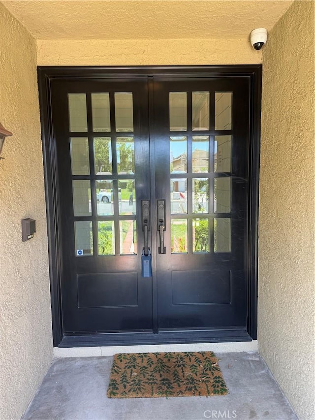 777 Oak Knoll St, Brea, CA 92821 - doorway to property with stucco siding, french doors, and a surveillance system