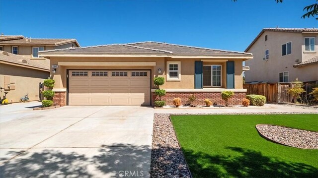 13849 Jackson St, Oak Hills, CA 92344 - prairie-style home featuring concrete driveway, brick siding, an attached garage, and stucco siding
