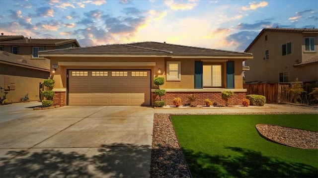 13849 Jackson St, Oak Hills, CA 92344 - prairie-style house with driveway, a garage, stucco siding, and brick siding