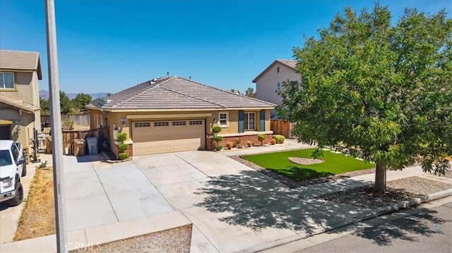 13849 Jackson St, Oak Hills, CA 92344 - view of front of house with an attached garage, concrete driveway, and stucco siding