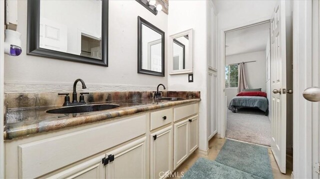 13849 Jackson St, Oak Hills, CA 92344 - bathroom featuring double vanity, ensuite bathroom, and wood finished floors