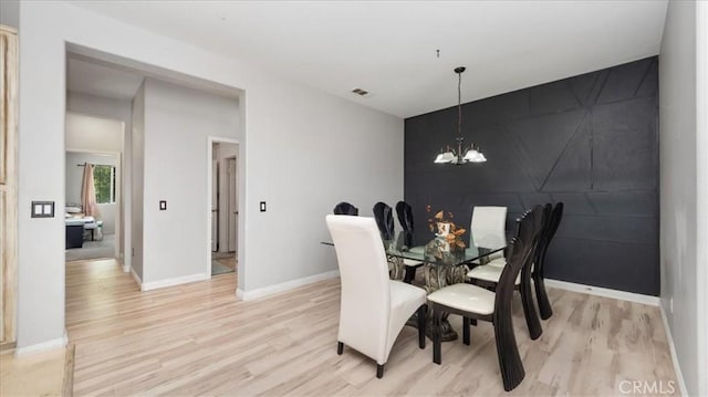 13849 Jackson St, Oak Hills, CA 92344 - dining room with light wood-type flooring and a chandelier