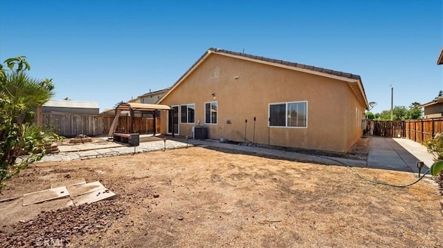 13849 Jackson St, Oak Hills, CA 92344 - back of house with a gazebo, a patio area, a fenced backyard, and stucco siding