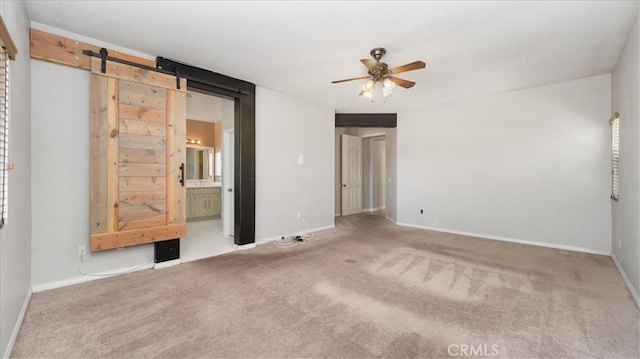 13849 Jackson St, Oak Hills, CA 92344 - spare room featuring a ceiling fan, carpet flooring, and a barn door