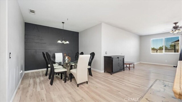13849 Jackson St, Oak Hills, CA 92344 - dining area with light wood-style flooring, a chandelier, and ceiling fan