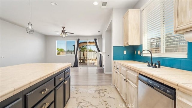 13849 Jackson St, Oak Hills, CA 92344 - kitchen with stainless steel dishwasher, tile counters, light marble finish flooring, ceiling fan, and pendant lighting