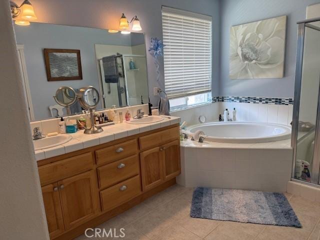 384 Papst Ave, Orland, CA 95963 - bathroom featuring a stall shower, a garden tub, double vanity, and tile patterned floors