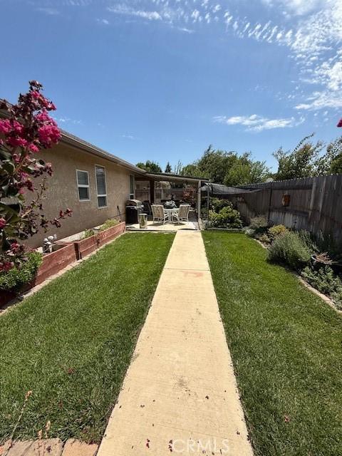 384 Papst Ave, Orland, CA 95963 - fenced backyard featuring a patio area