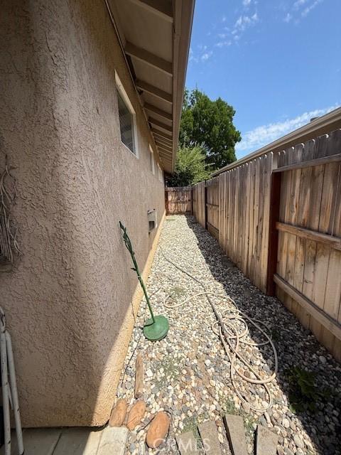384 Papst Ave, Orland, CA 95963 - view of side of property featuring stucco siding and a fenced backyard