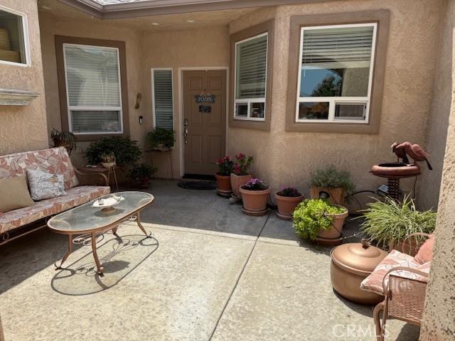 384 Papst Ave, Orland, CA 95963 - doorway to property featuring a patio area and stucco siding