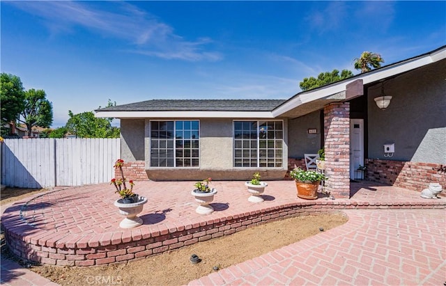 625 Balboa Dr, Corona, CA 92879 - view of exterior entry with stucco siding and a patio
