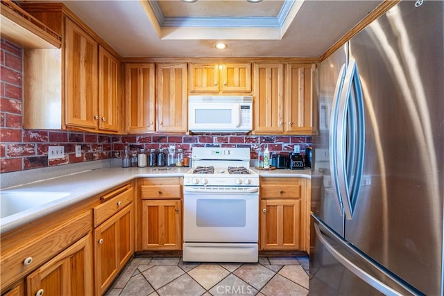 625 Balboa Dr, Corona, CA 92879 - kitchen featuring white appliances, a raised ceiling, light countertops, crown molding, and tasteful backsplash