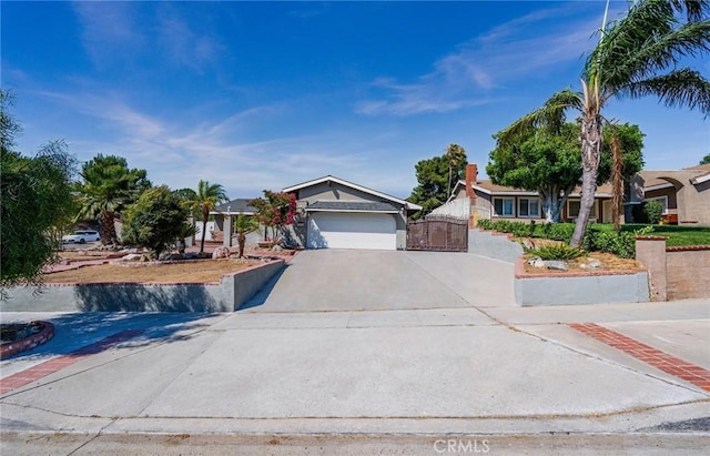 625 Balboa Dr, Corona, CA 92879 - obstructed view of property featuring concrete driveway, an attached garage, and a gate