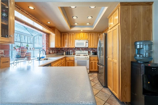 625 Balboa Dr, Corona, CA 92879 - kitchen with white appliances, a raised ceiling, a peninsula, decorative backsplash, and light countertops