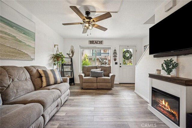 2444 La Costa Ct, Oceano, CA 93445 - living room with a ceiling fan, wood finished floors, and a glass covered fireplace