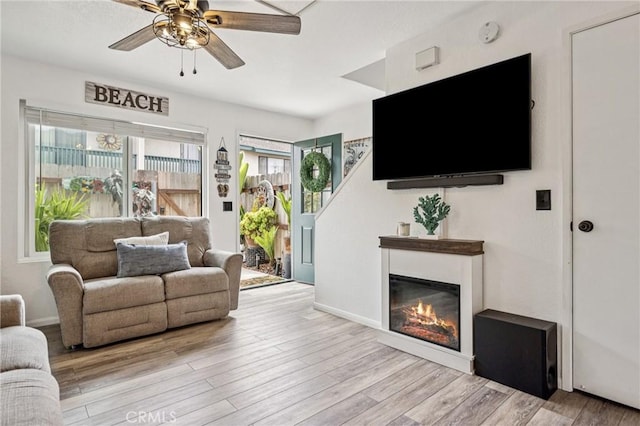 2444 La Costa Ct, Oceano, CA 93445 - living room featuring ceiling fan, wood finished floors, and a glass covered fireplace