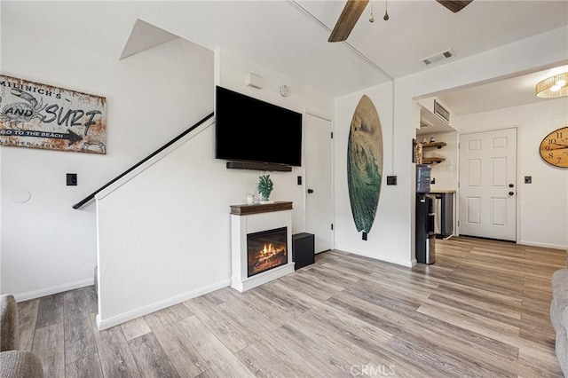 2444 La Costa Ct, Oceano, CA 93445 - unfurnished living room with ceiling fan, wood finished floors, and a glass covered fireplace