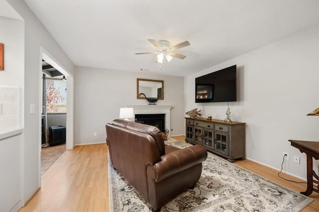 675 Barberry Way, Nipomo, CA 93444 - living area featuring a ceiling fan, a fireplace, and light wood-style flooring