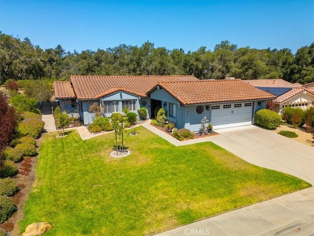 675 Barberry Way, Nipomo, CA 93444 - view of front of house featuring an attached garage, driveway, a tiled roof, a front yard, and stucco siding