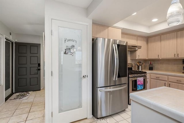675 Barberry Way, Nipomo, CA 93444 - kitchen with appliances with stainless steel finishes, light brown cabinets, under cabinet range hood, tile countertops, and decorative backsplash