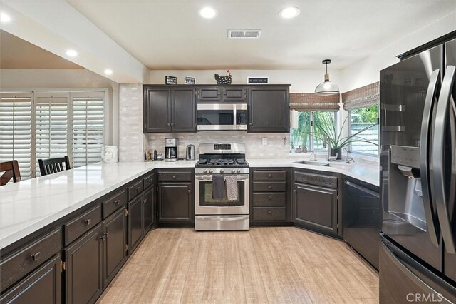 26309 Emerald Dove Dr, Valencia, CA 91355 - kitchen featuring appliances with stainless steel finishes, light countertops, recessed lighting, light wood-style floors, and tasteful backsplash
