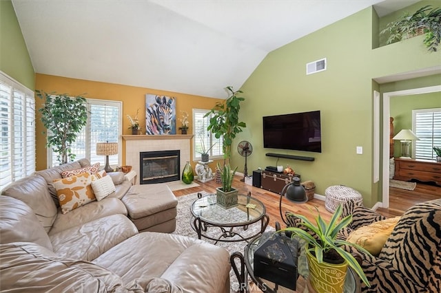 26309 Emerald Dove Dr, Valencia, CA 91355 - living room with wood finished floors, lofted ceiling, plenty of natural light, and a tile fireplace