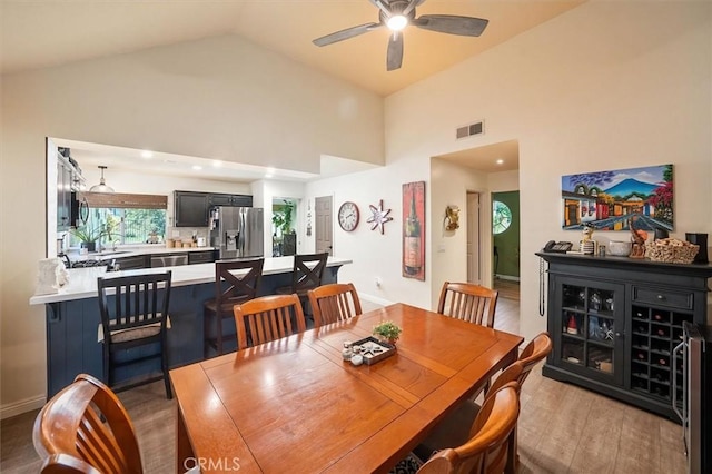 26309 Emerald Dove Dr, Valencia, CA 91355 - dining area with wine cooler, a ceiling fan, wood finished floors, and high vaulted ceiling