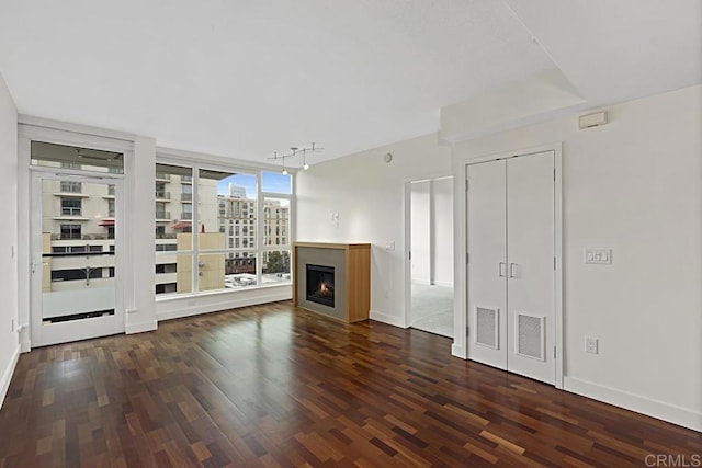 325 7th Ave Unit 609, San Diego, CA 92101 - unfurnished living room with wood finished floors, rail lighting, and a lit fireplace