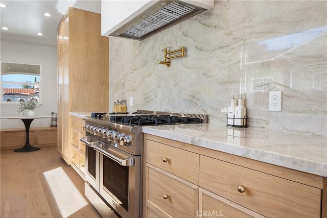 3924 Dublin Ave, Los Angeles, CA 90008 - kitchen featuring range with two ovens, custom range hood, light stone counters, decorative backsplash, and light wood-style flooring