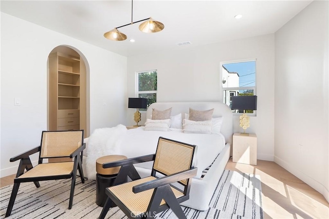 3924 Dublin Ave, Los Angeles, CA 90008 - bedroom featuring arched walkways, light wood-style flooring, and recessed lighting