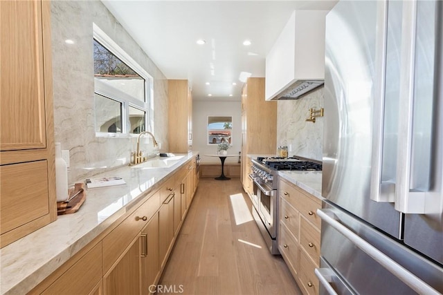 3924 Dublin Ave, Los Angeles, CA 90008 - kitchen with appliances with stainless steel finishes, premium range hood, light wood-style floors, decorative backsplash, and light stone counters