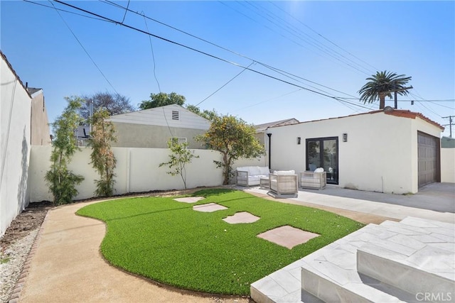 3924 Dublin Ave, Los Angeles, CA 90008 - fenced backyard featuring an outdoor living space, a garage, and a patio