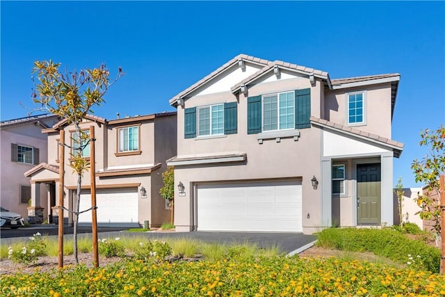 501 Pablo Rd Unit 48, Lake Elsinore, CA 92530 - view of front of property with an attached garage, a tiled roof, stucco siding, and asphalt driveway