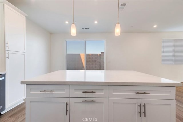 501 Pablo Rd Unit 48, Lake Elsinore, CA 92530 - kitchen featuring light wood-style flooring, white cabinetry, light countertops, pendant lighting, and recessed lighting