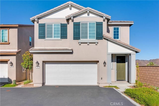 501 Pablo Rd Unit 48, Lake Elsinore, CA 92530 - view of front of house featuring an attached garage, stucco siding, and driveway