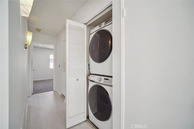 26970 Flo Ln Unit 310, Canyon Country, CA 91351 - laundry area with stacked washer / drying machine and light wood-style floors