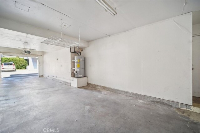 26970 Flo Ln Unit 310, Canyon Country, CA 91351 - garage with strapped water heater and a garage door opener
