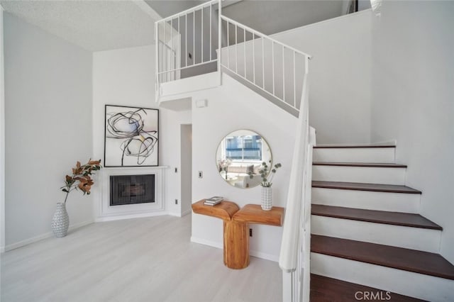 26970 Flo Ln Unit 310, Canyon Country, CA 91351 - stairway featuring wood finished floors and a fireplace