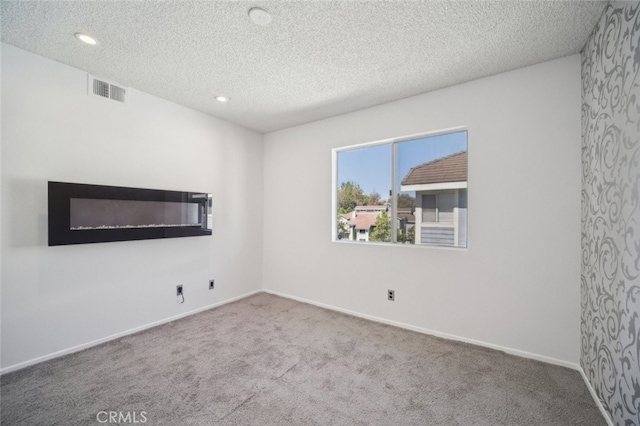 26970 Flo Ln Unit 310, Canyon Country, CA 91351 - carpeted spare room with a textured ceiling and recessed lighting