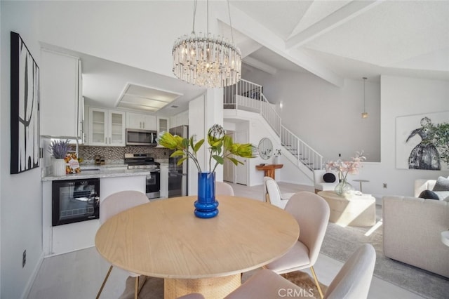 26970 Flo Ln Unit 310, Canyon Country, CA 91351 - dining area featuring wine cooler, stairs, beamed ceiling, and a chandelier