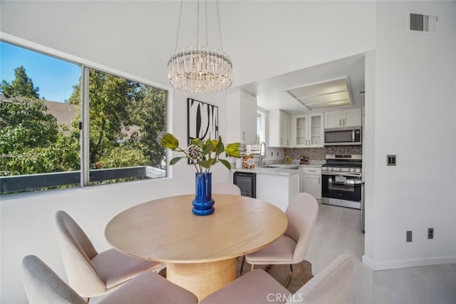 26970 Flo Ln Unit 310, Canyon Country, CA 91351 - dining area with a chandelier and light wood-type flooring