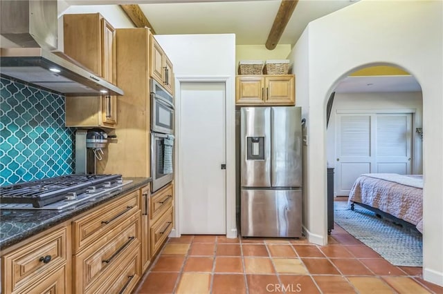 3606 W Chandler Blvd, Burbank, CA 91505 - kitchen featuring stainless steel appliances, wall chimney range hood, arched walkways, backsplash, and light tile patterned flooring
