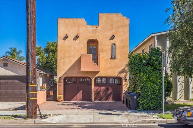 3606 W Chandler Blvd, Burbank, CA 91505 - view of front of home with stucco siding, a garage, and decorative driveway