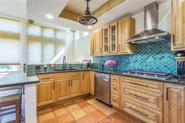 3606 W Chandler Blvd, Burbank, CA 91505 - kitchen featuring wall chimney range hood, appliances with stainless steel finishes, decorative backsplash, glass insert cabinets, and dark stone counters